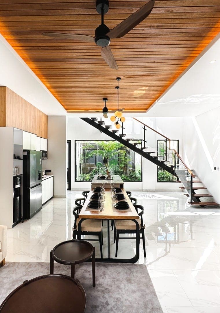 Modern Bali villa interior with wooden ceiling and open staircase